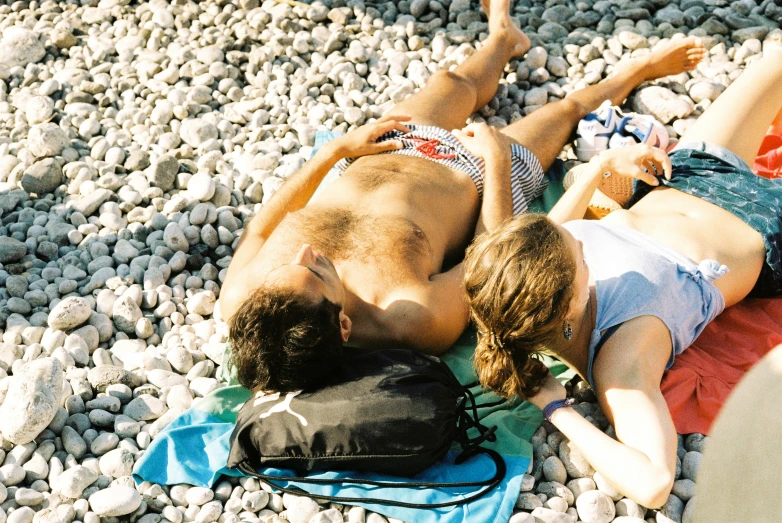 a couple lying on their back on some rocks