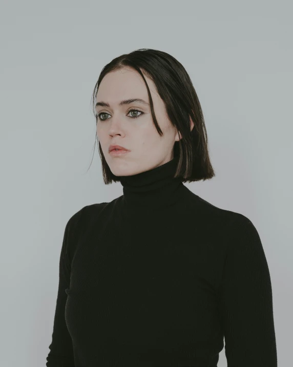 a young woman with long black hair is looking away