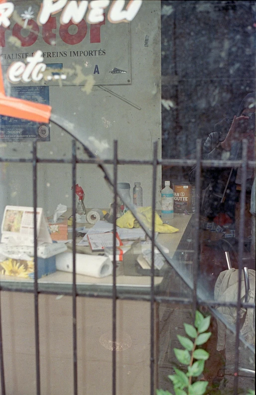 a view through a fence of a street vendor's counter