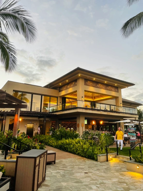 a huge house with people walking through the front