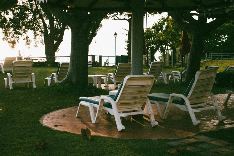 chairs and chairs on a lawn in the evening light