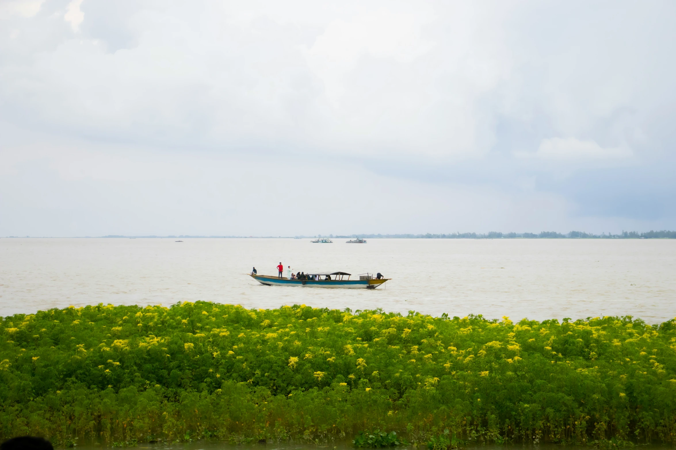 two boats in the water on a cloudy day