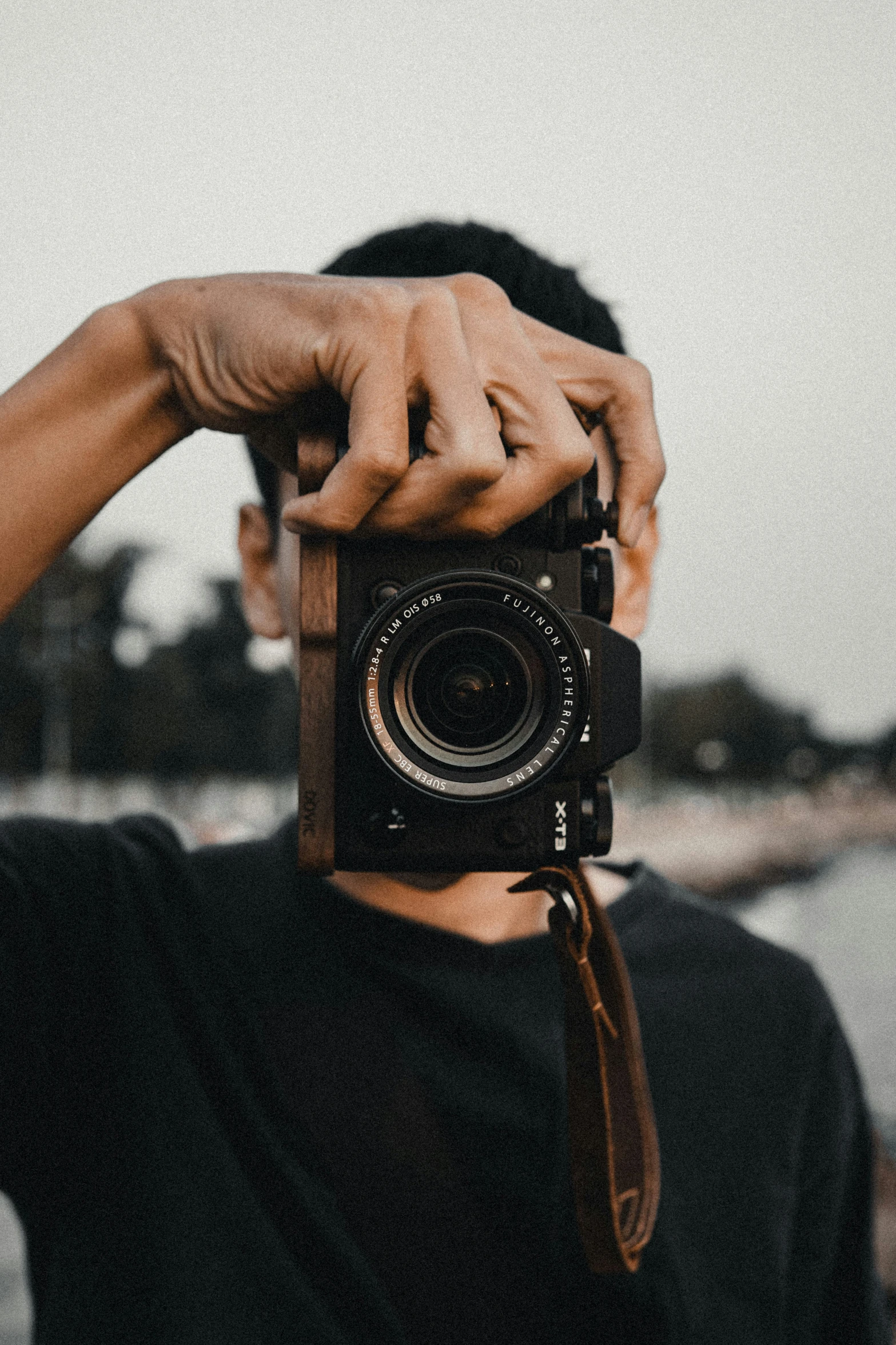 a man holding up his camera to take a po