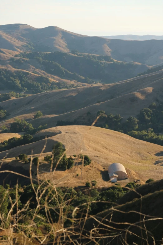 an outhouse sits in the middle of the mountains