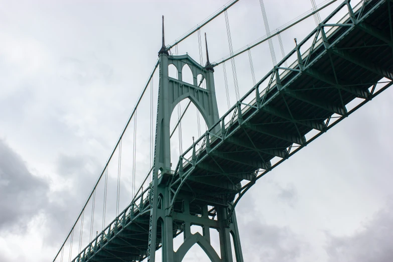 a large bridge with lots of ropes underneath it