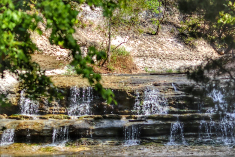 a waterfall that is flowing into the woods