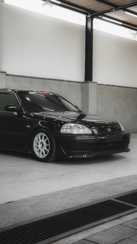 a car is sitting in the garage next to the door