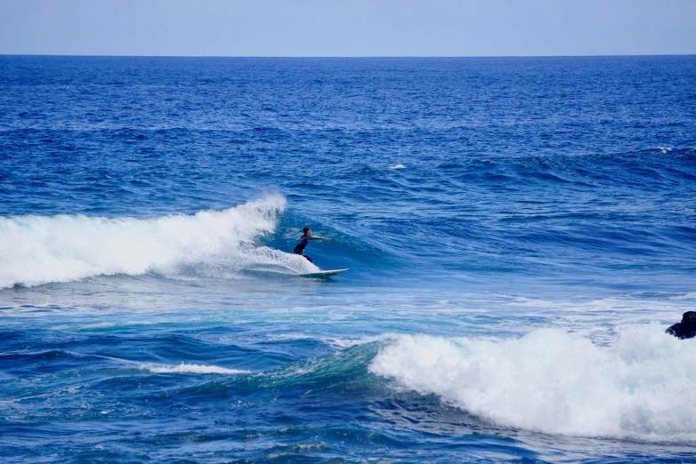 the surfer is riding a big wave in the ocean