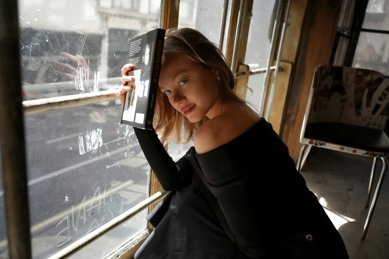 a  looking out the window of a passenger train