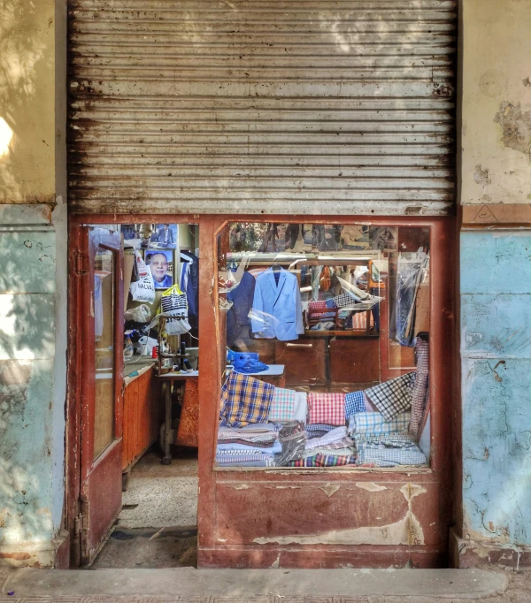 the storefront is covered in lots of clothes