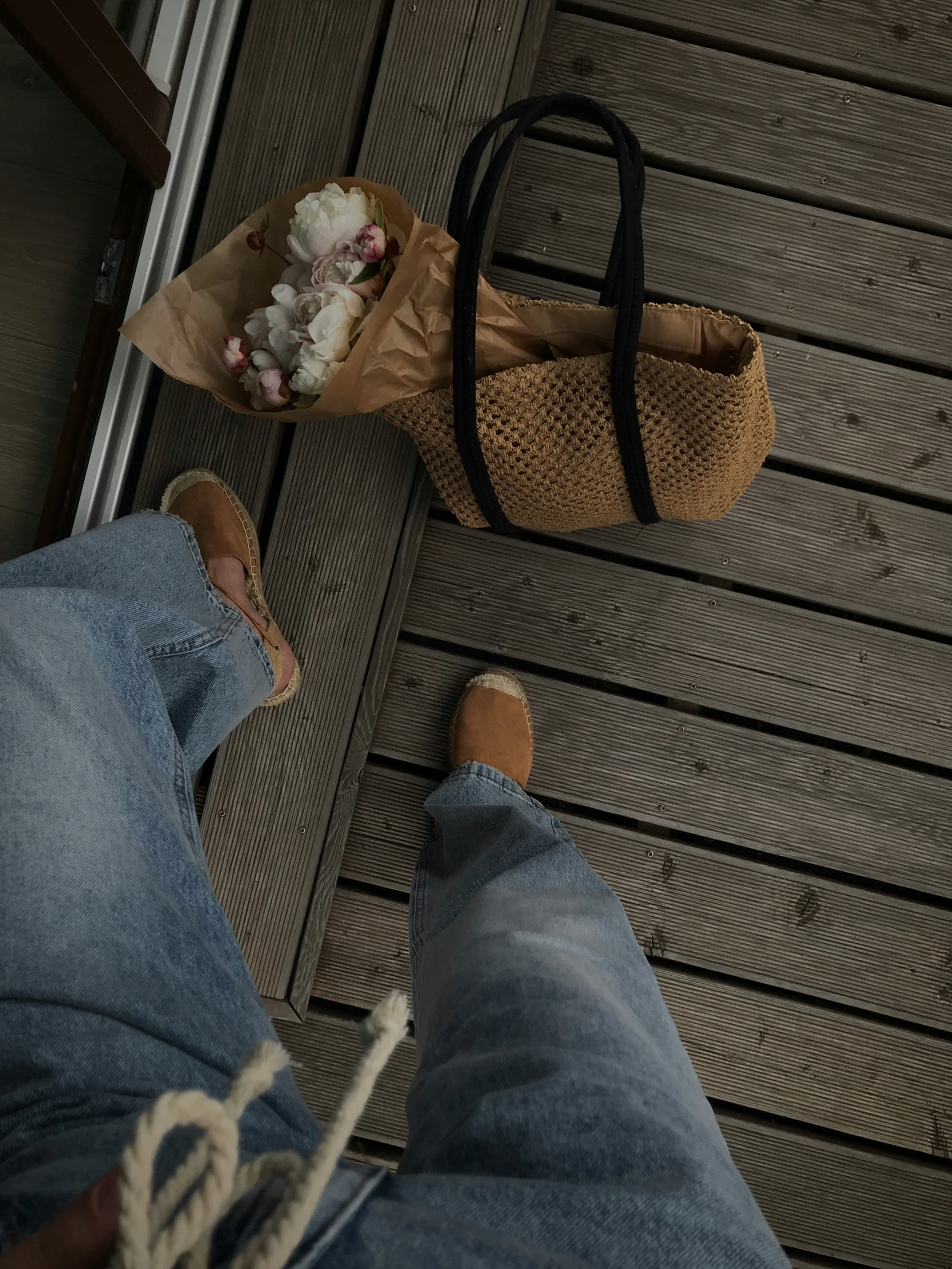 a person has their feet up and has a bag next to them