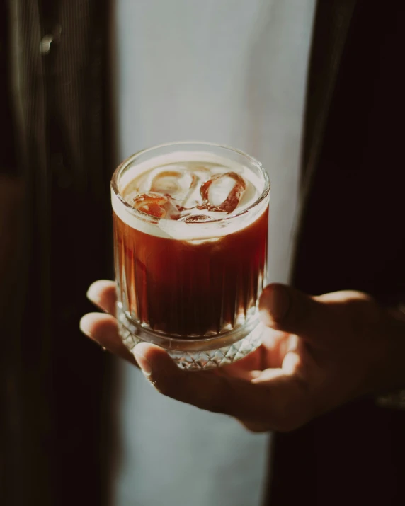 an image of a man holding an alcohol