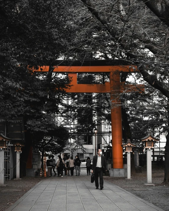 many people are walking in a large asian shrine