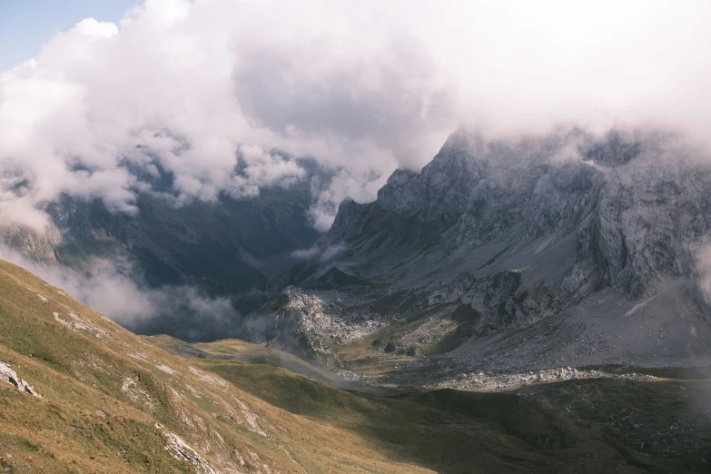 there are two sheep on the top of a mountain