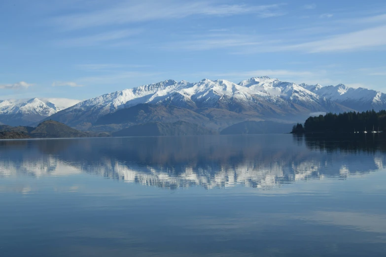 an alpine mountain range reflect in the water