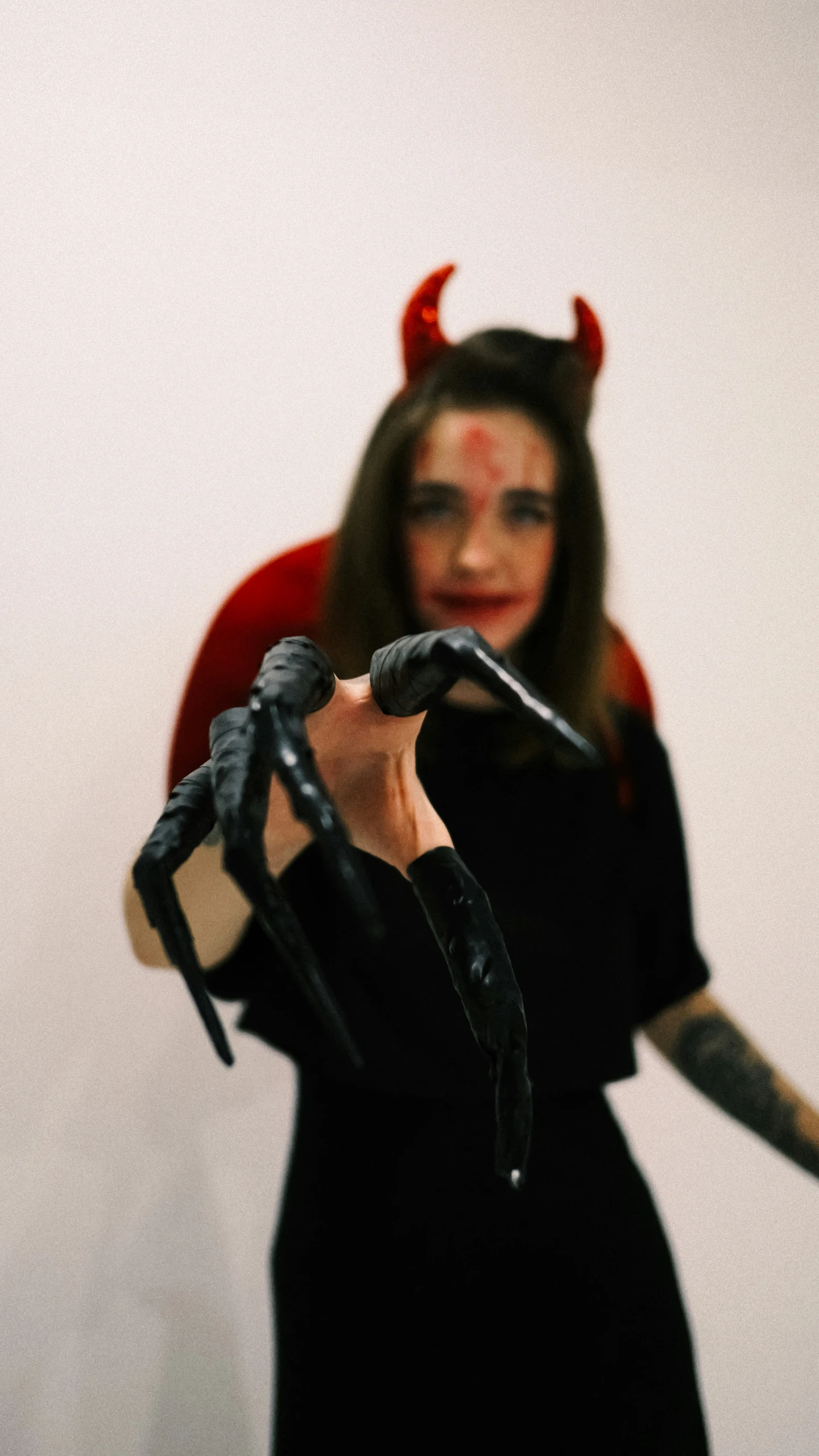 a woman with horns is shown holding two scissors