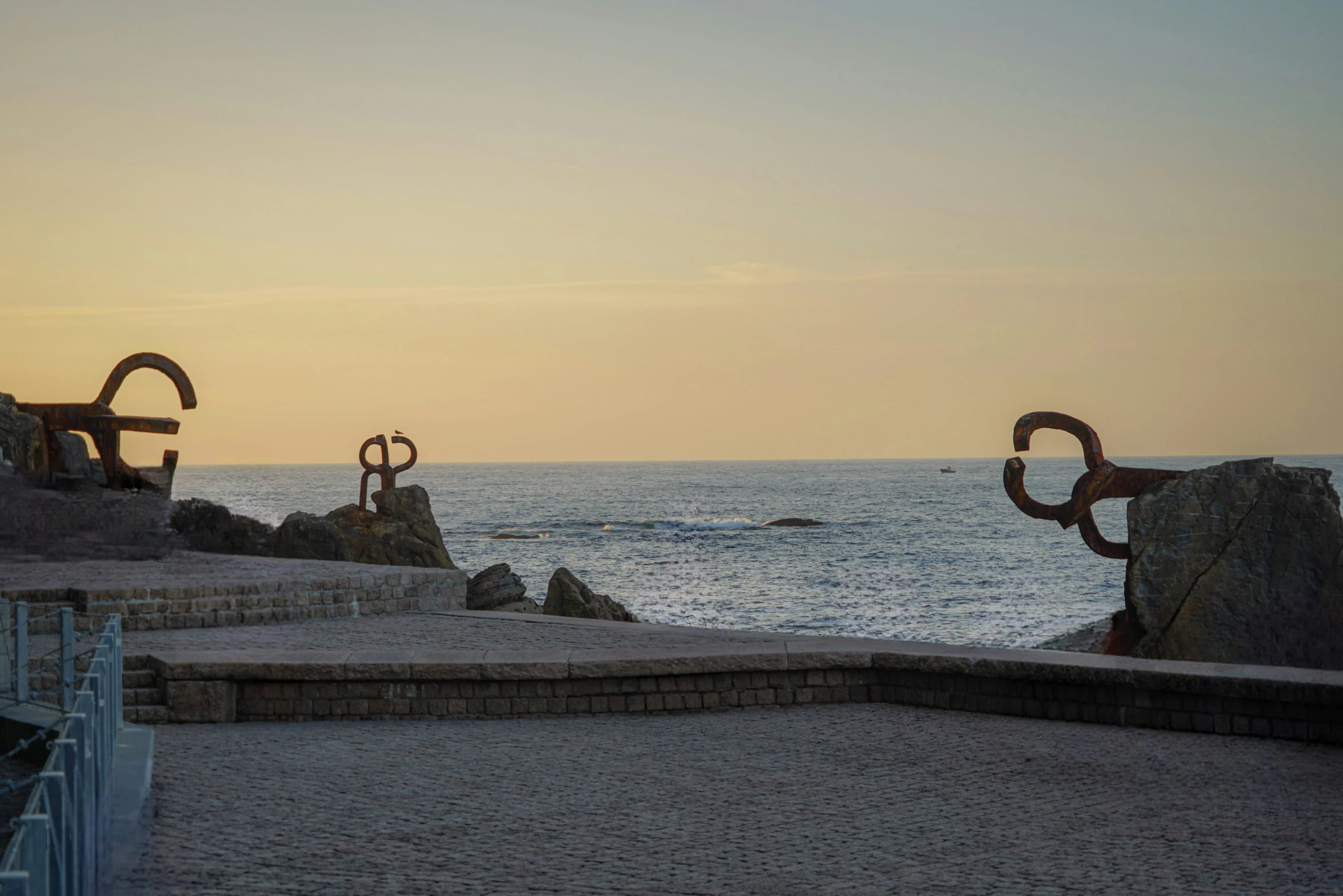 a po of some sculptures on the shore