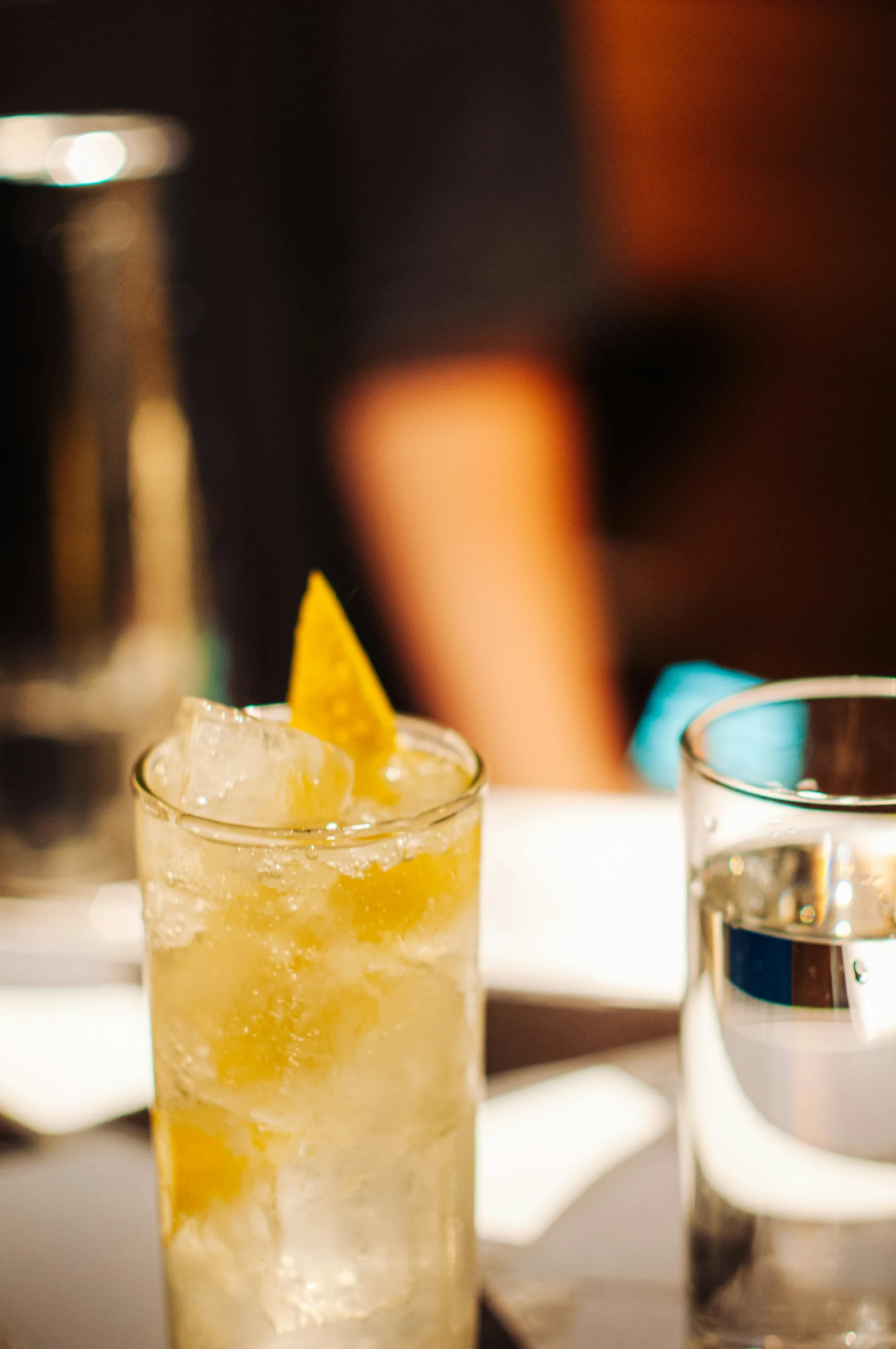 the pitcher and glass have two yellow slices on it