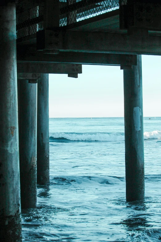 a body of water next to a wooden pier