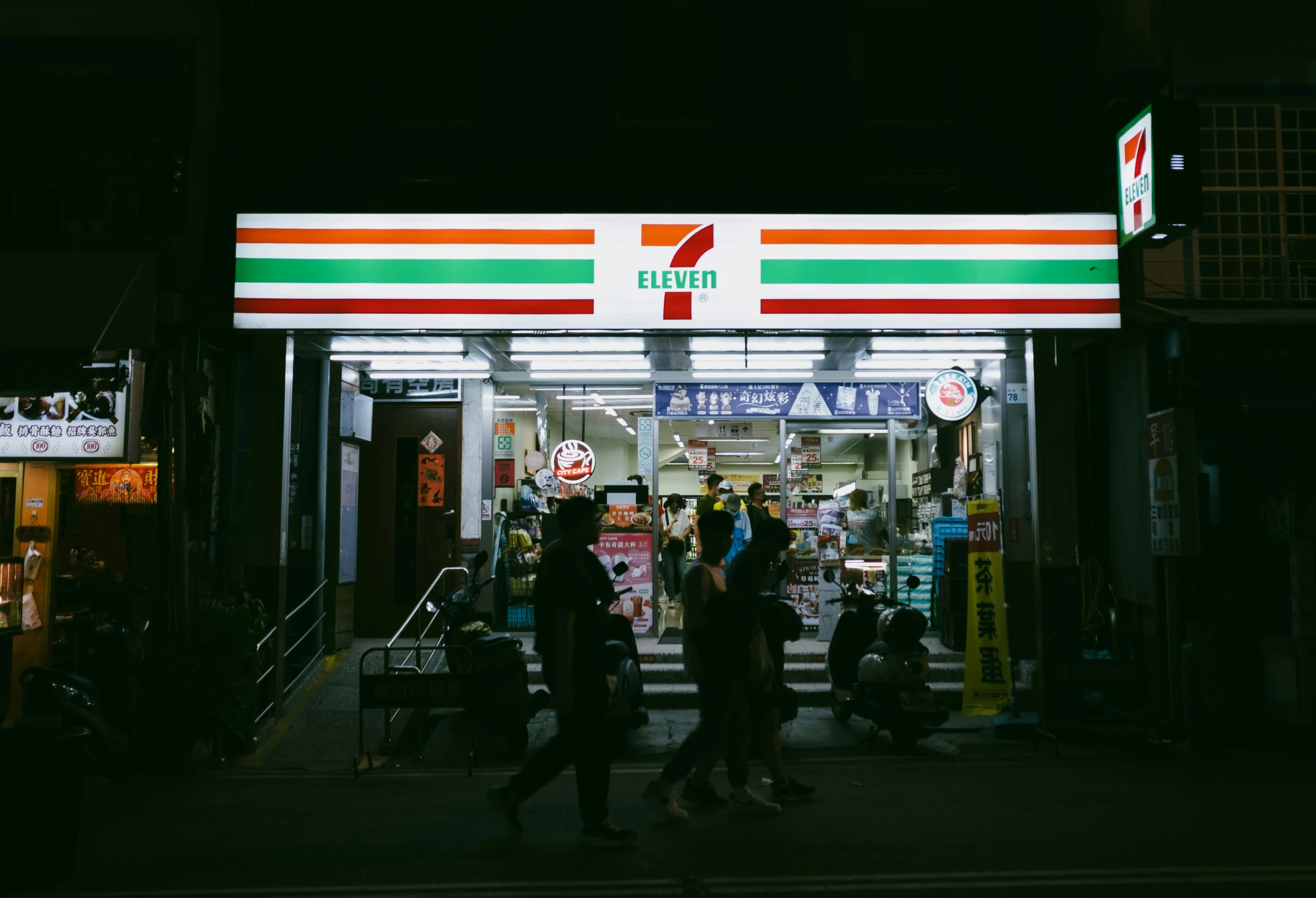 two people in front of a gas station