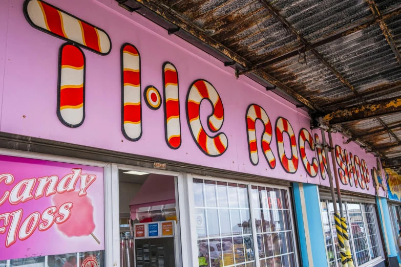 candy pop in front of a building with colorful windows