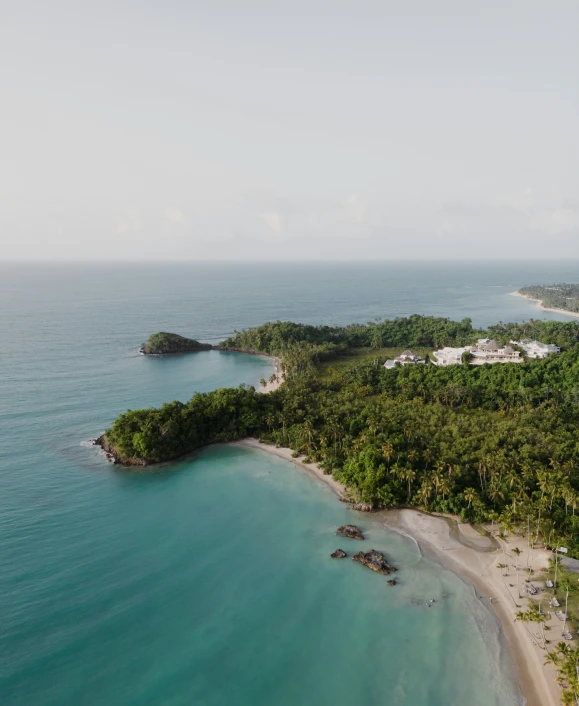 an aerial s of a sandy beach area in a tropical island