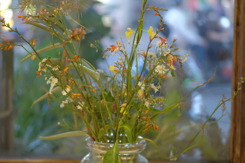 a small jar that has some flowers in it