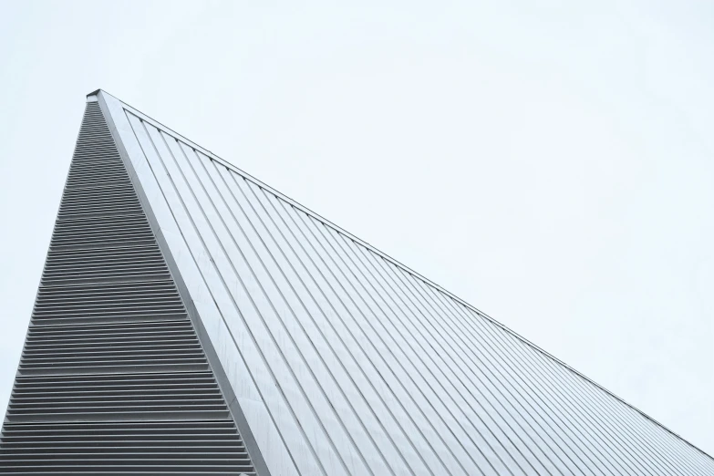 a triangular shaped building with lines going across it