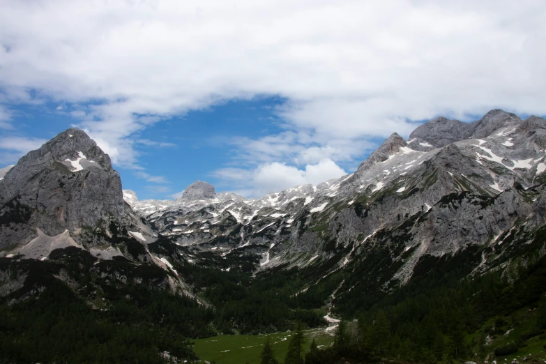 the sky is very cloudy for this snowy mountain