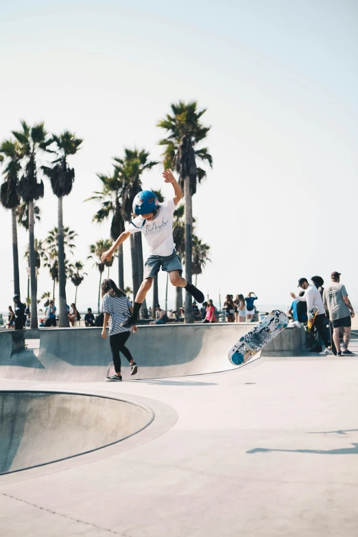 several people watching a man doing a trick on a skateboard