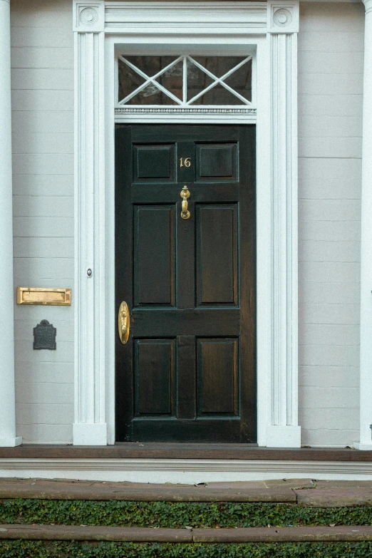 black double door with ss knock on front of house