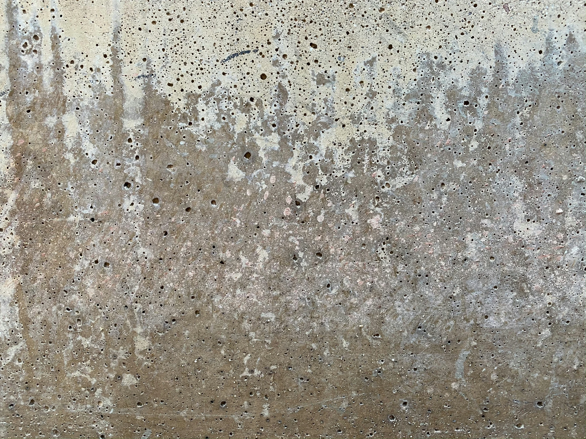 a tan, brown and black cement background with a clock