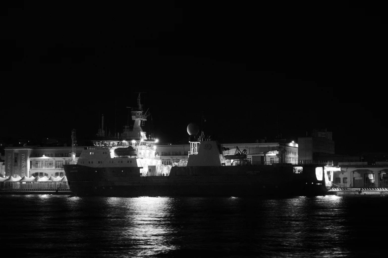 a ship is floating in the water with buildings in the background