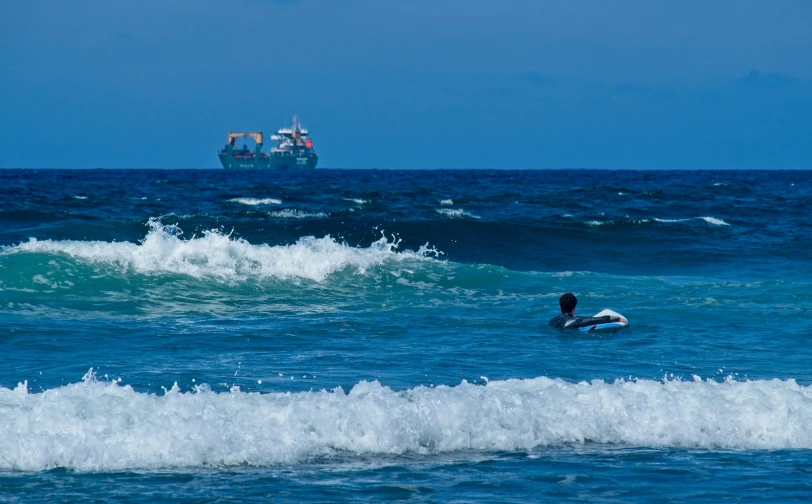 a man is riding on a surfboard in the water