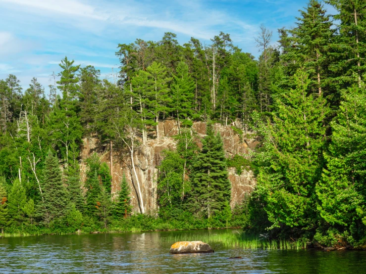 this is the view of a lake with trees surrounding it