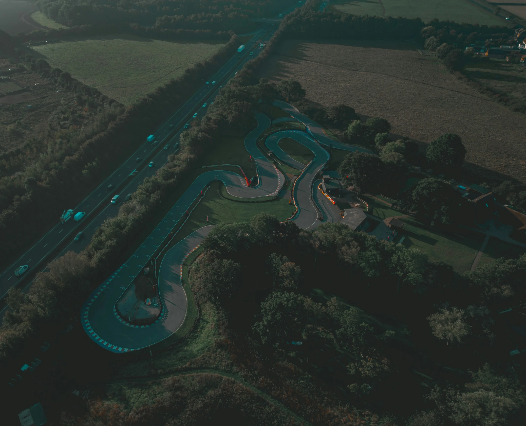 a small aerial po showing the top view of a winding road