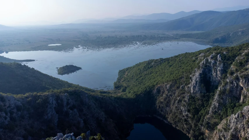 a lake sits in the middle of some mountains