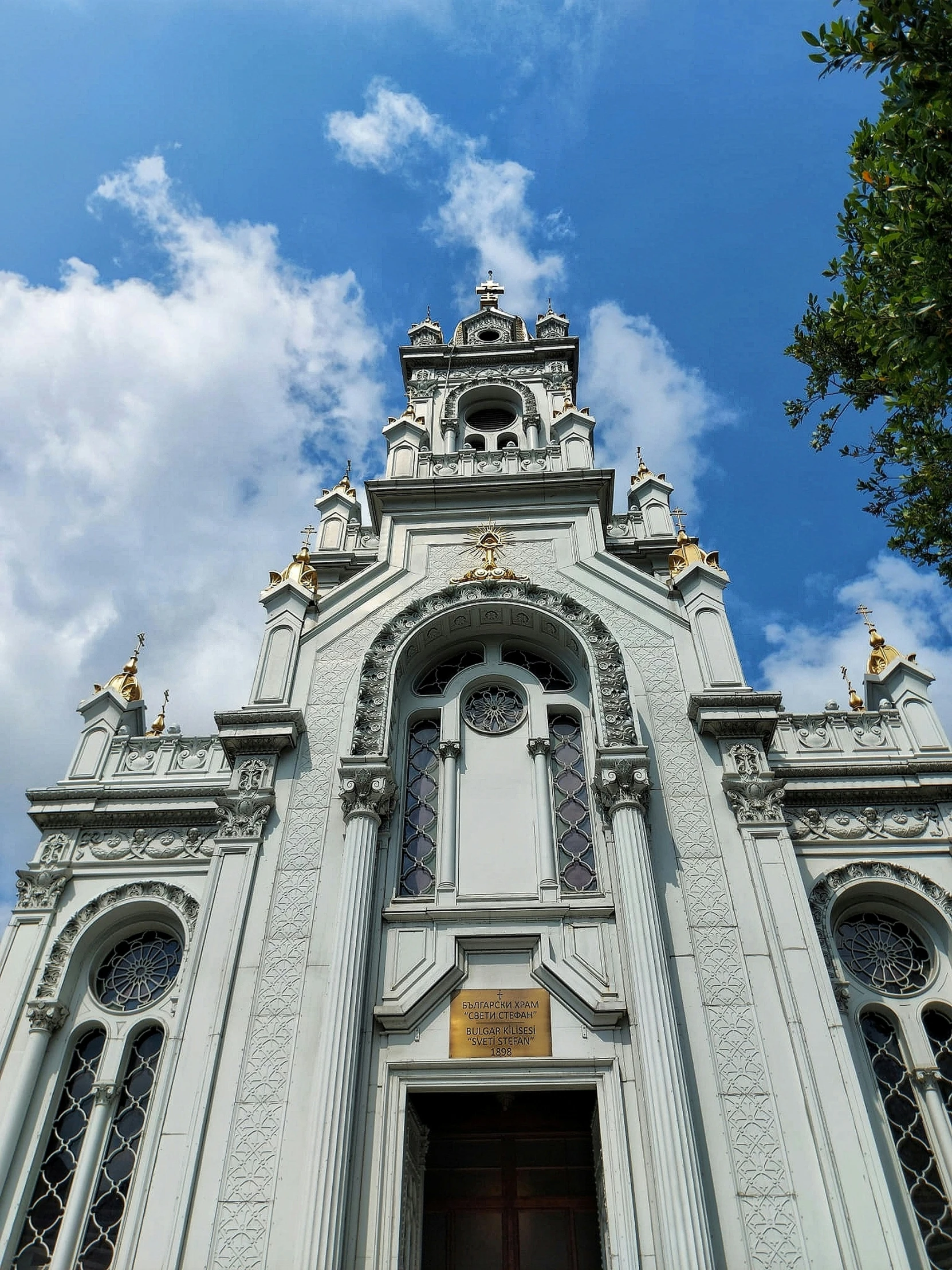 a white building has a clock tower