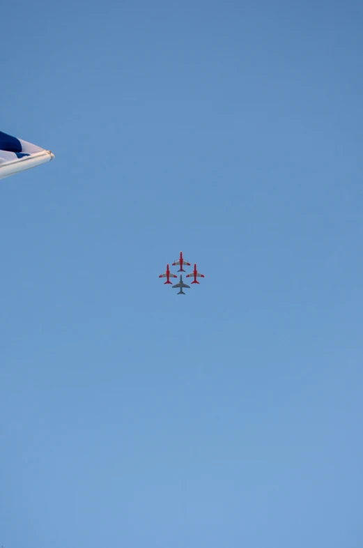 two airplanes in formation in blue skies