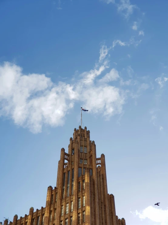 a building is shown against a blue sky with some clouds