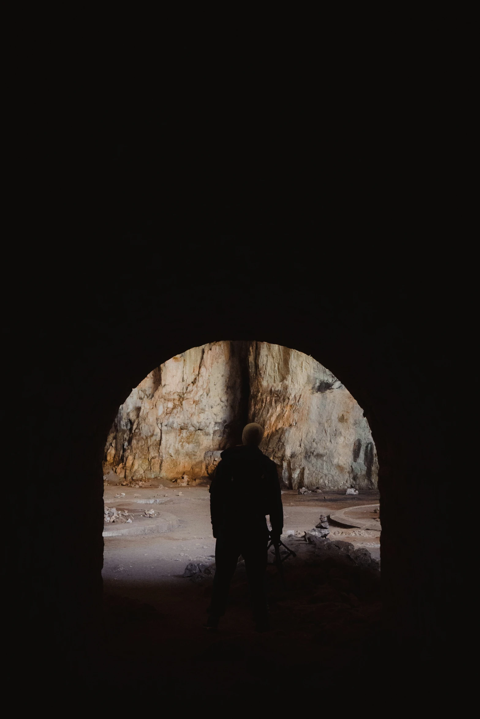 two people are standing in an open tunnel