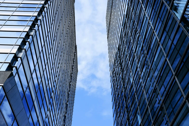 a view looking up at two tall buildings
