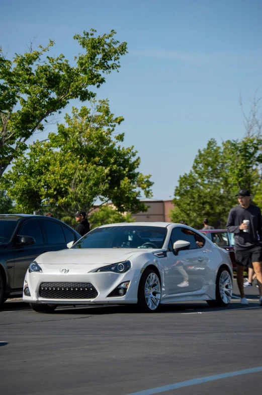 two sports cars parked on the side of the road