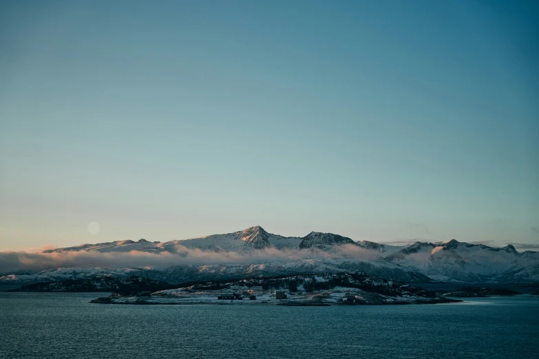 a scenic view of a beautiful mountain range in the evening