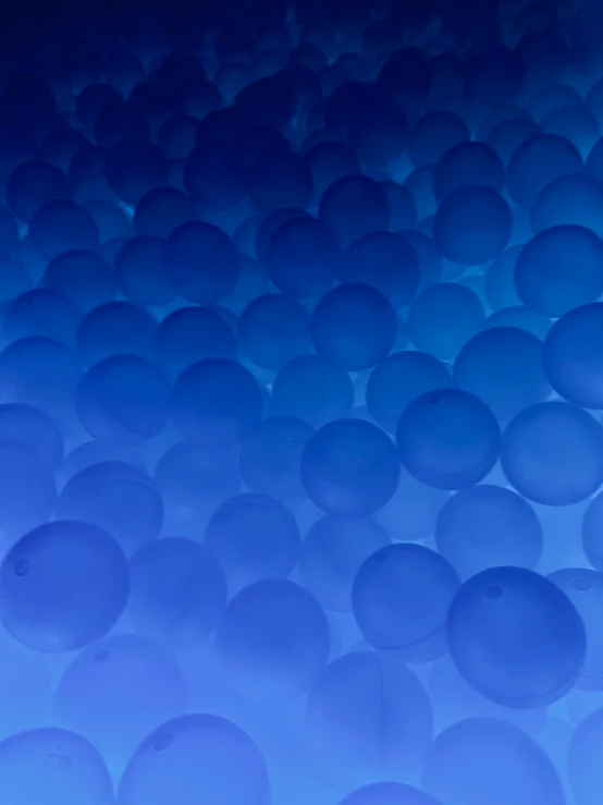 a wall of blue balls that have been hed in one direction