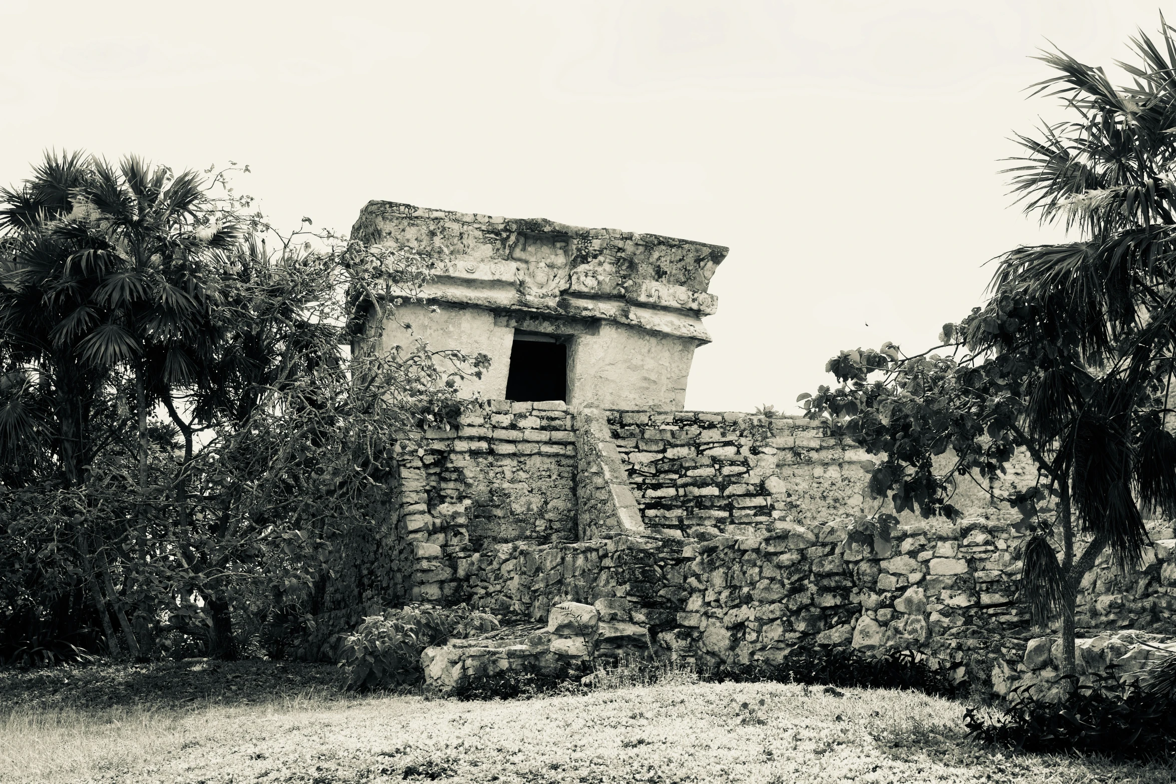 a very old brick wall with an open door