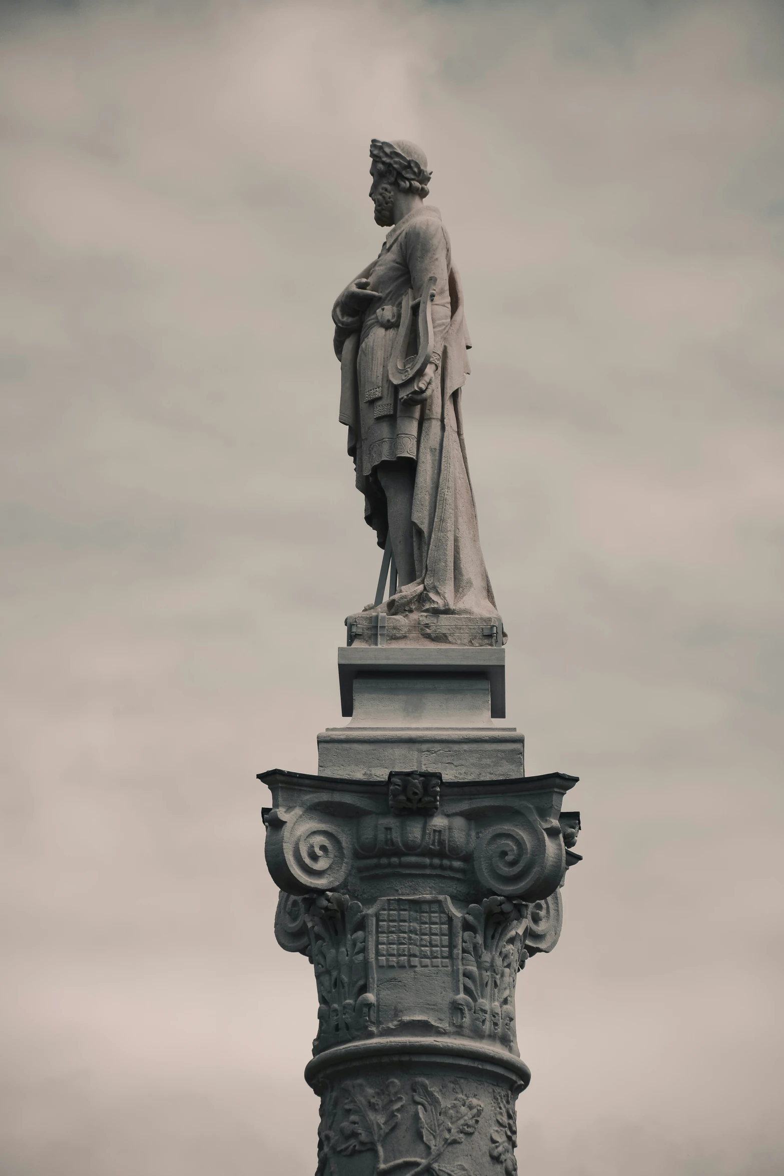 a statue is sitting on top of a pedestal