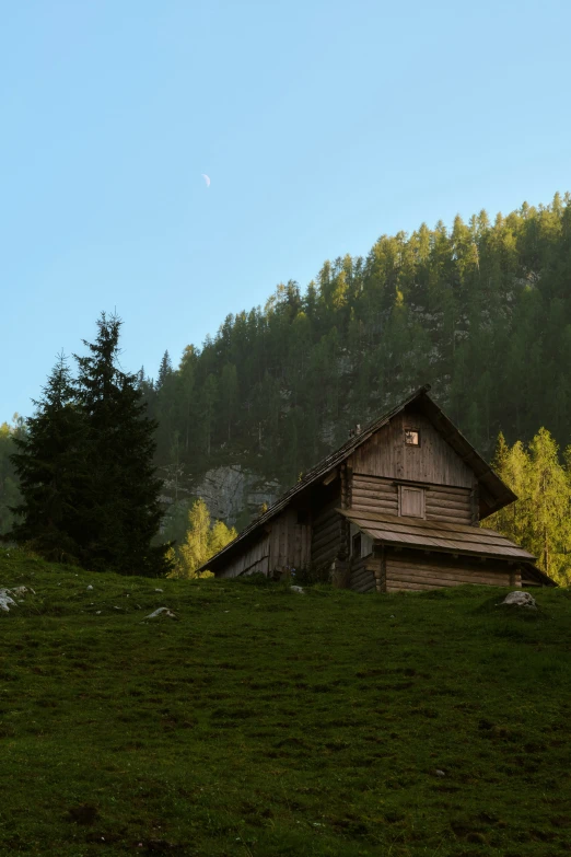 two small wooden houses sitting on top of a grass field