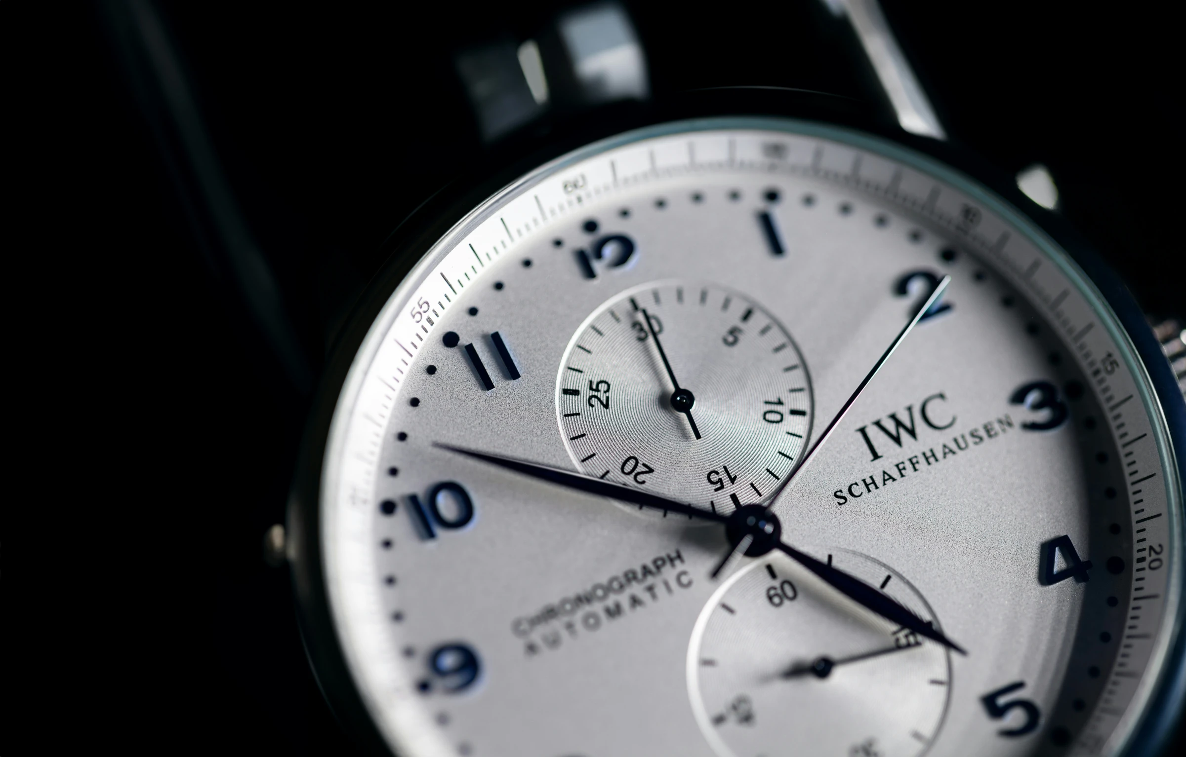 a white wrist watch sitting on top of a watch case