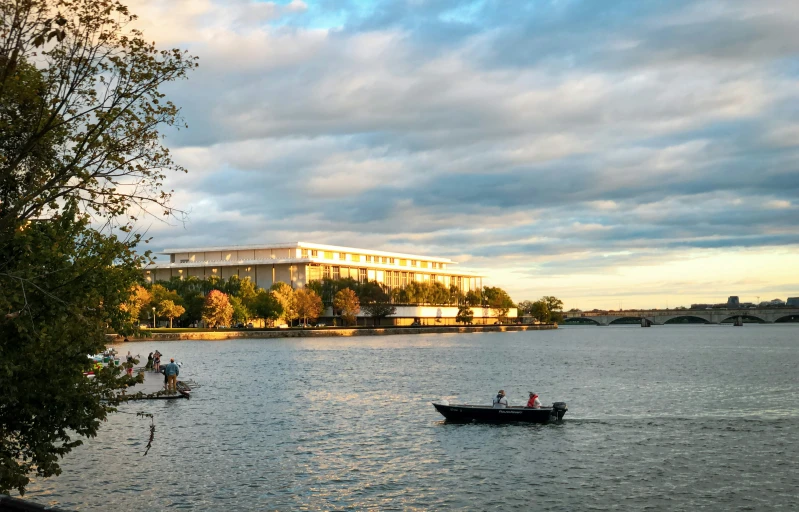 two people sit in the canoes in front of an office building